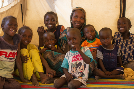 Nadia and her family in a camp in Sudan. Photo credit: George Wambugu/CAFOD
