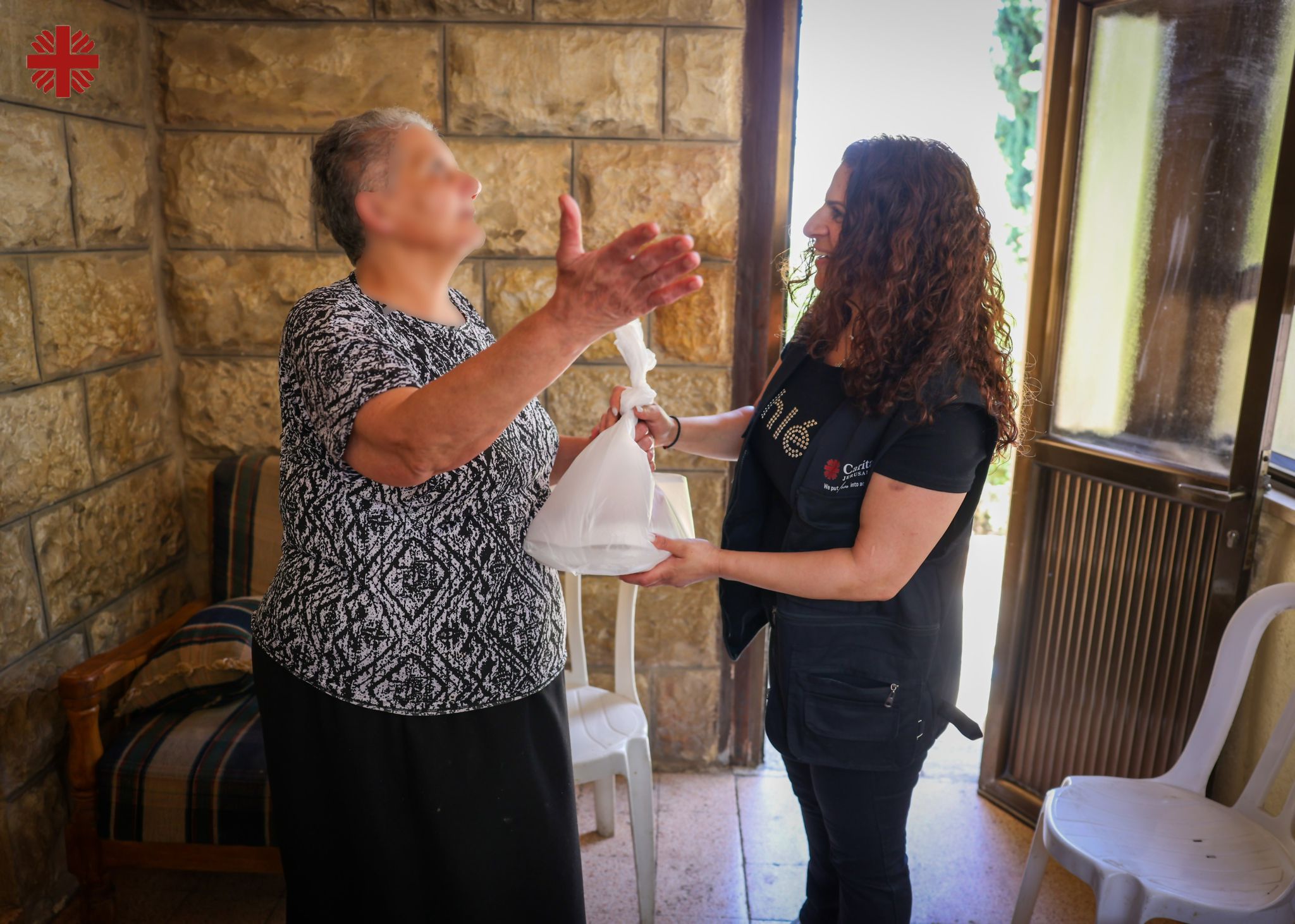 Caritas Jerusalem Volunteers Distributing Food To The Elderly In The West Bank