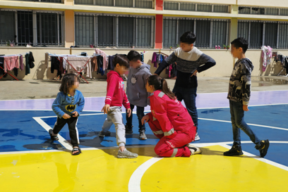 Children with a Caritas Lebanon worker at a collective shelter site photo credit Caritas Lebanon.jpg