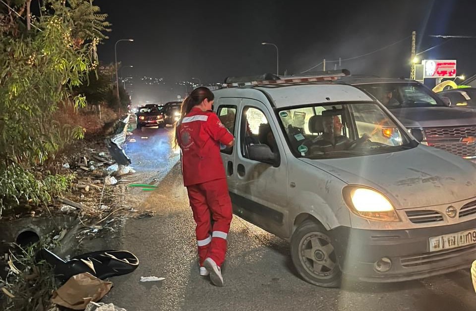 A Caritas Worker Hands Out Water Alongside The Road Photo Credit Caritas Lebanon