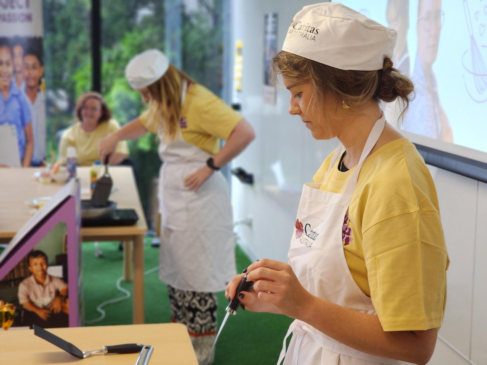 Paige and Tara at making Pancakes at the Project Compassion 2025 Office Launch