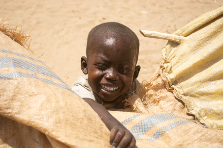 Smiling child in Sudan. Photo credit: George Wambugu/CAFOD (1)