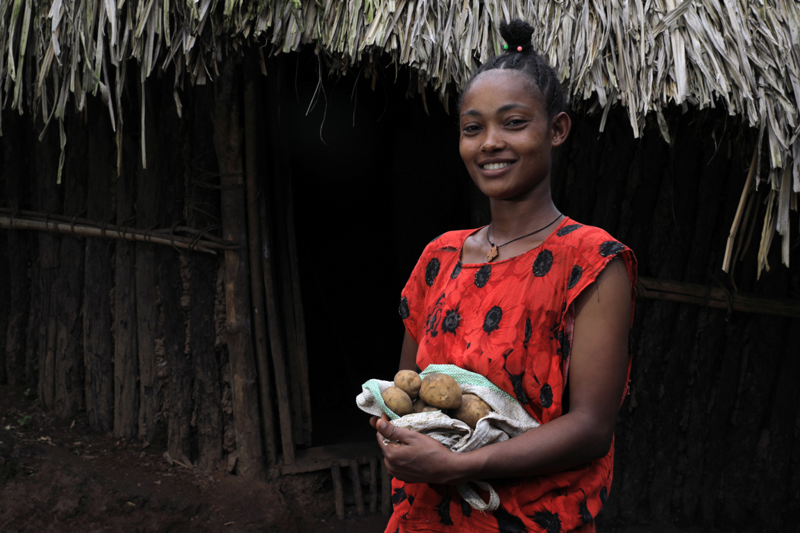 Yeshareg With Potatoes Outside Her Home