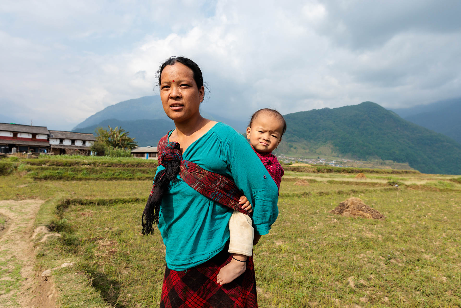 NEPAL Woman Carrying Her Baby In Fields