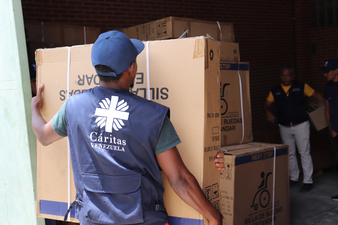 Caritas Team Delivering Wheelchairs To People In Need.