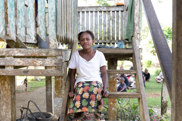 Patricia sitting outside her home in Solomon Islands. Photo: Caritas Australia