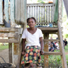 Patricia sitting outside her home in Solomon Islands. Photo: Caritas Australia