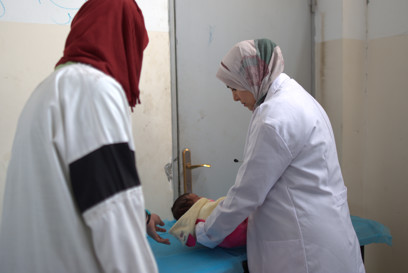 A baby recieves medical care from a Caritas health worker in Gaza photo credit Trocaire.jpg