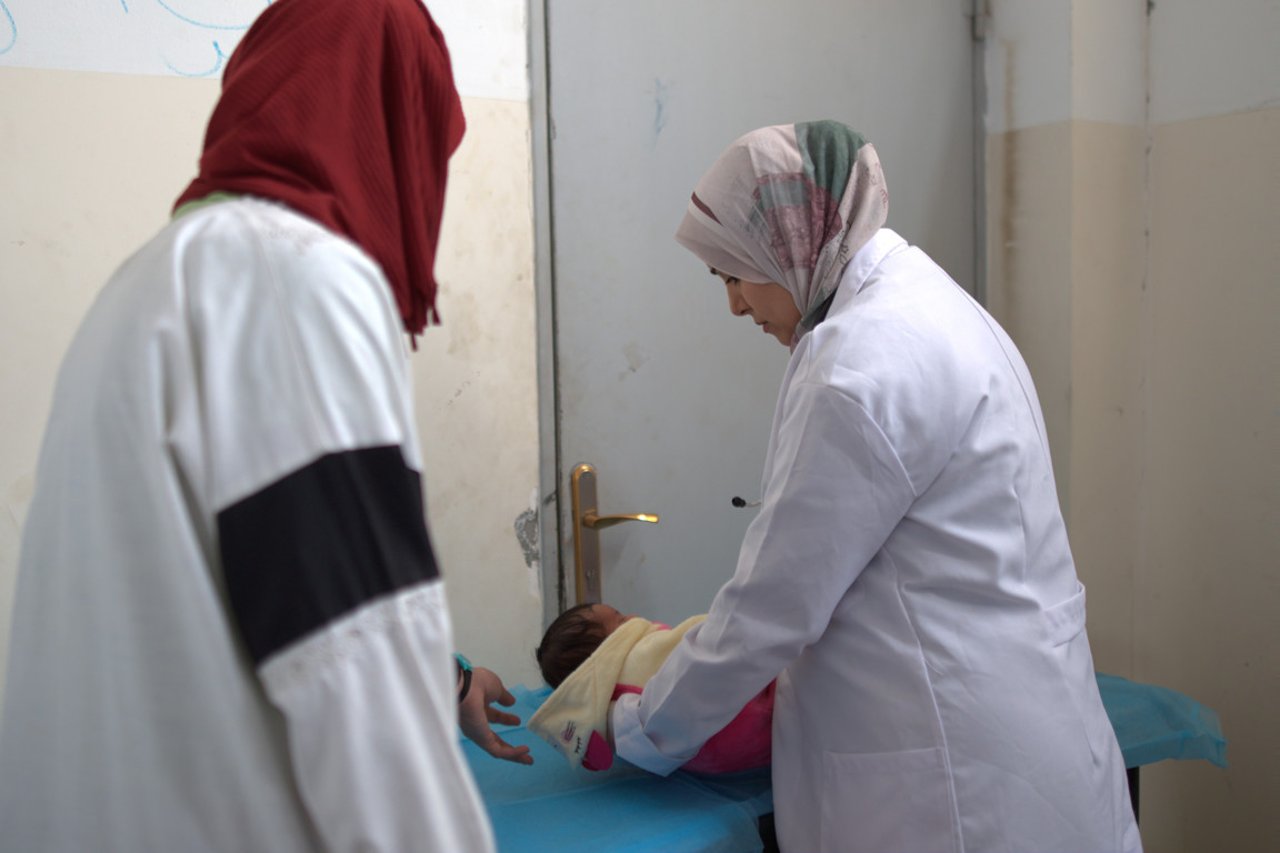 A baby recieves medical care from a Caritas health worker in Gaza photo credit Trocaire.jpg