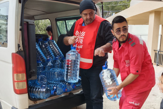 Caritas Lebanon aid workers distributing emergency water.jpg
