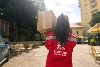 A member of Caritas Youth carries a box of aid photo credit Caritas Lebanon.jpg