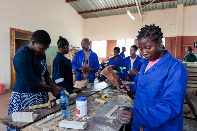 Women learning carpentry at a technical college in Malawi. Photo: Tim Lam/Caritas Australia