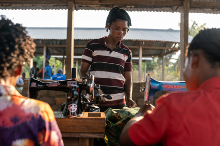 Irene Standing In Front Of Her Sewing Machine