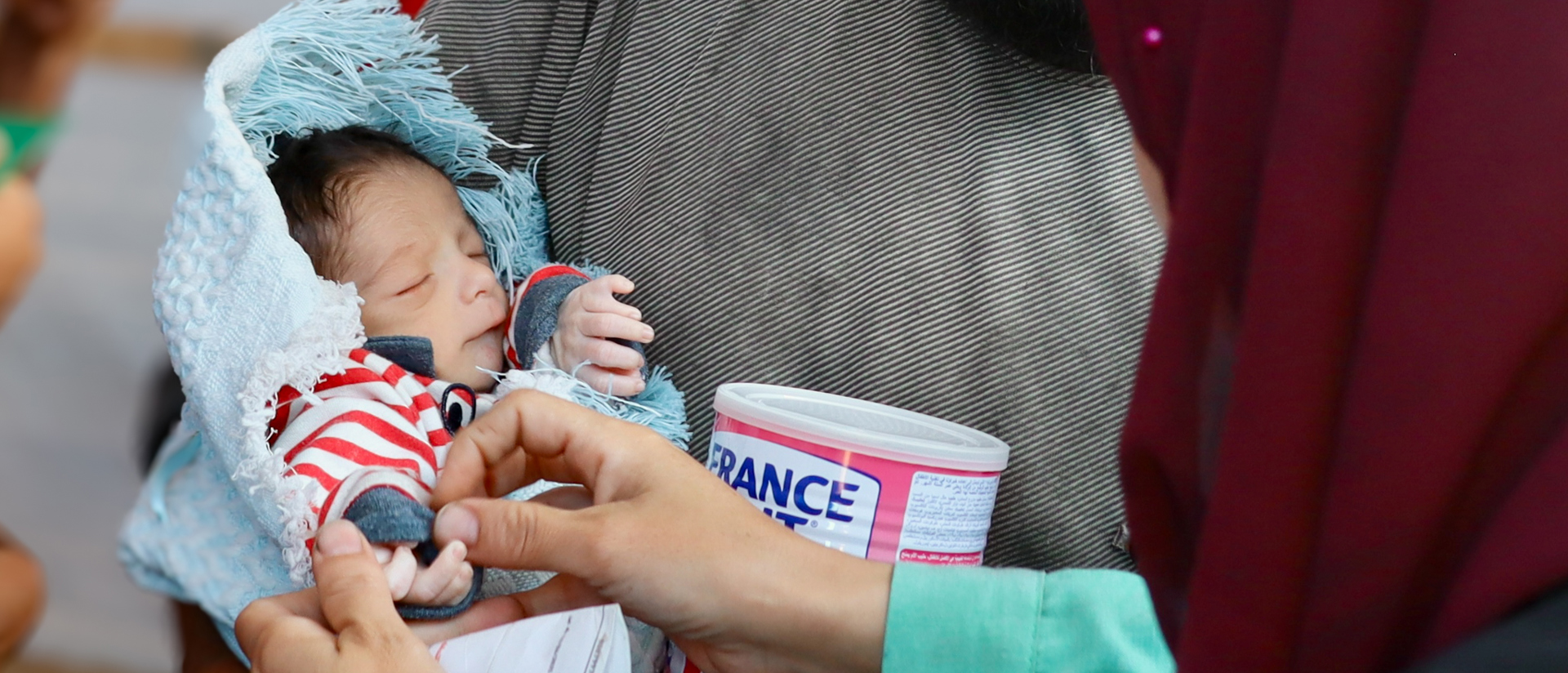 An Aid Worker And A Family As They Receive Infant Formula In Khan Younis Refugee Camp Photo Credit Caritras Jerusalem