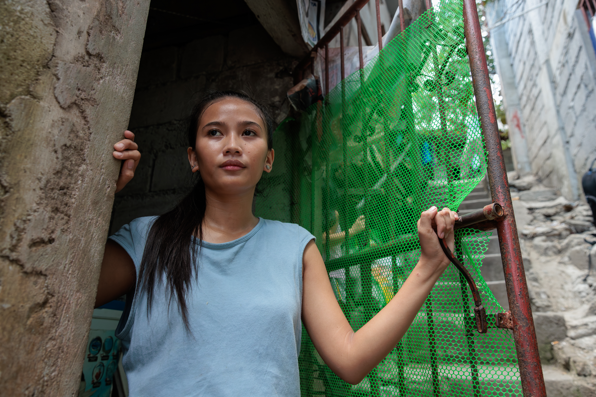 Ronita Looking Outside Of Her Home In The Phillipines