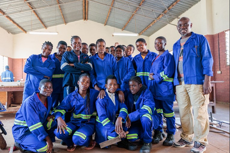 Memory with current students at her former technical training college in Blantyre, Malawi. Photo: Tim Lam/Caritas Australia