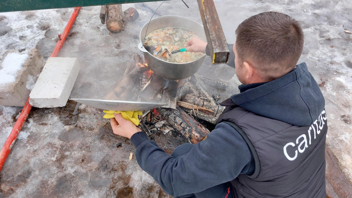 A Man Cooks Outside In Ukraine Photo Credit Elisabeth Sellmeier For Caritas Vienna