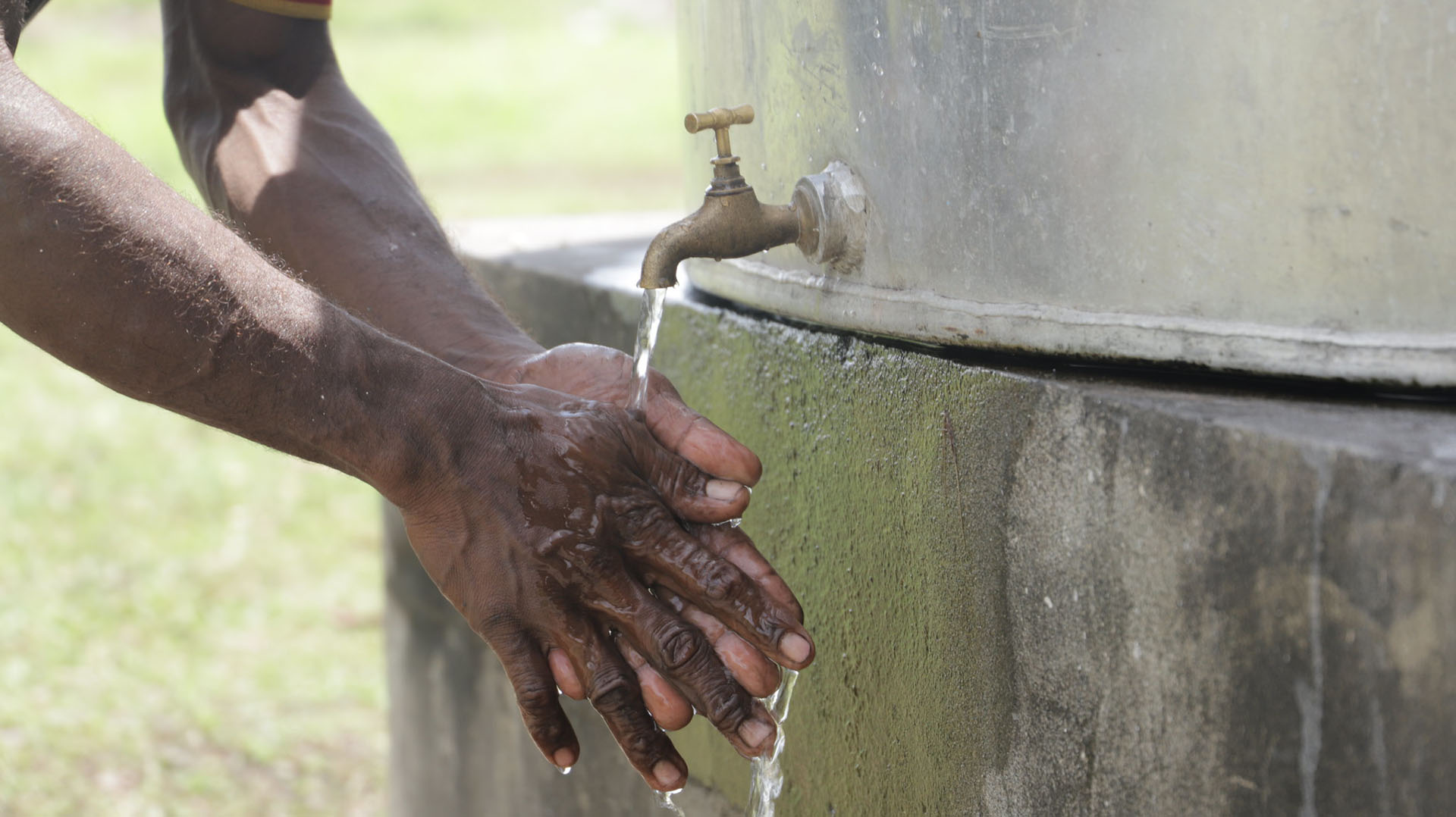 Washing Hands Using A New Water Tank In The Solomons