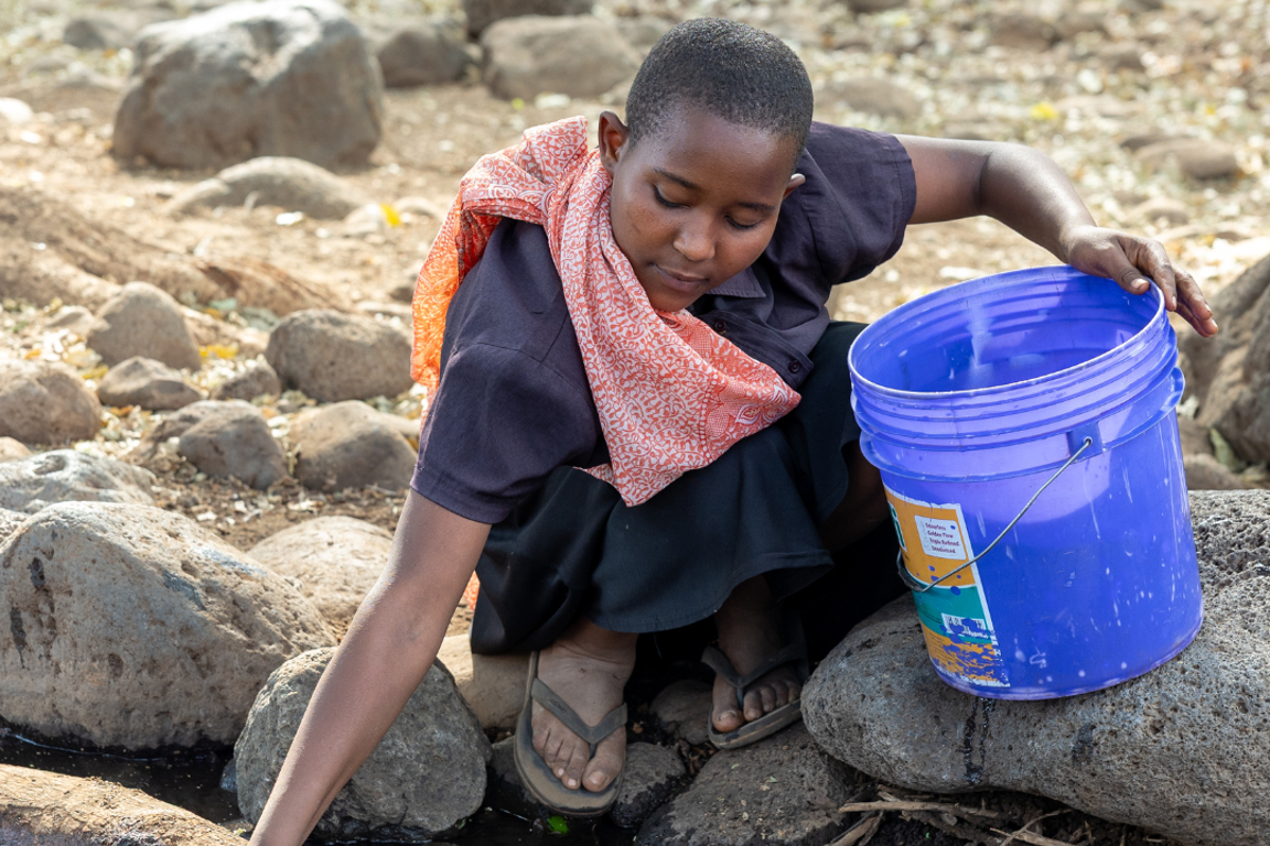 Sisilia Collecting Water From Nearby Creek