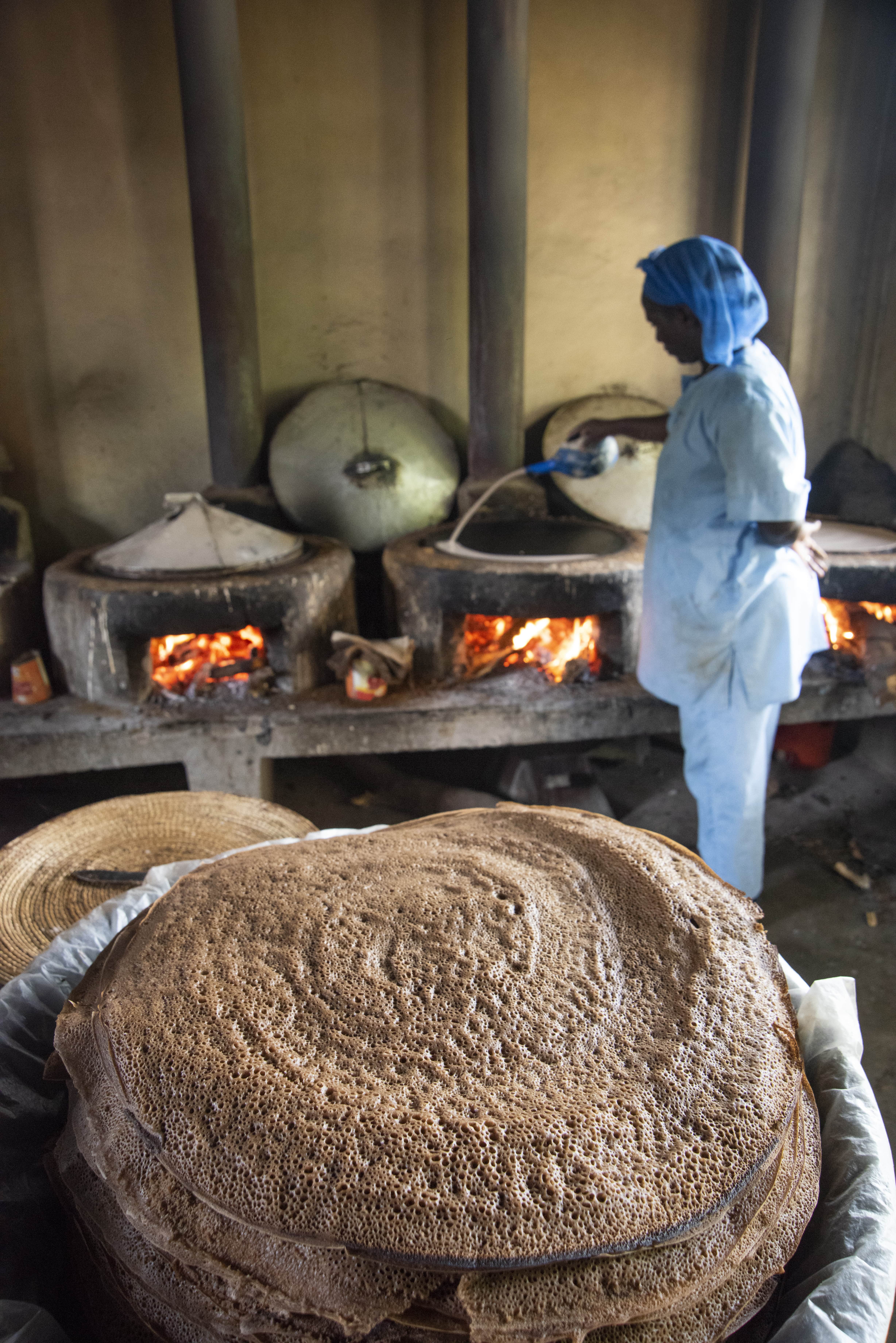 Staff member cooks injera – a local bread – at a missionary-run health facility
