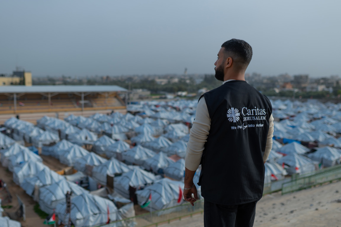 A Caritas Jerusalem worker looks out at temporary shelters that continue to house most of the popualtion of Gaza photo credit Caritas Jerusalem.jpg