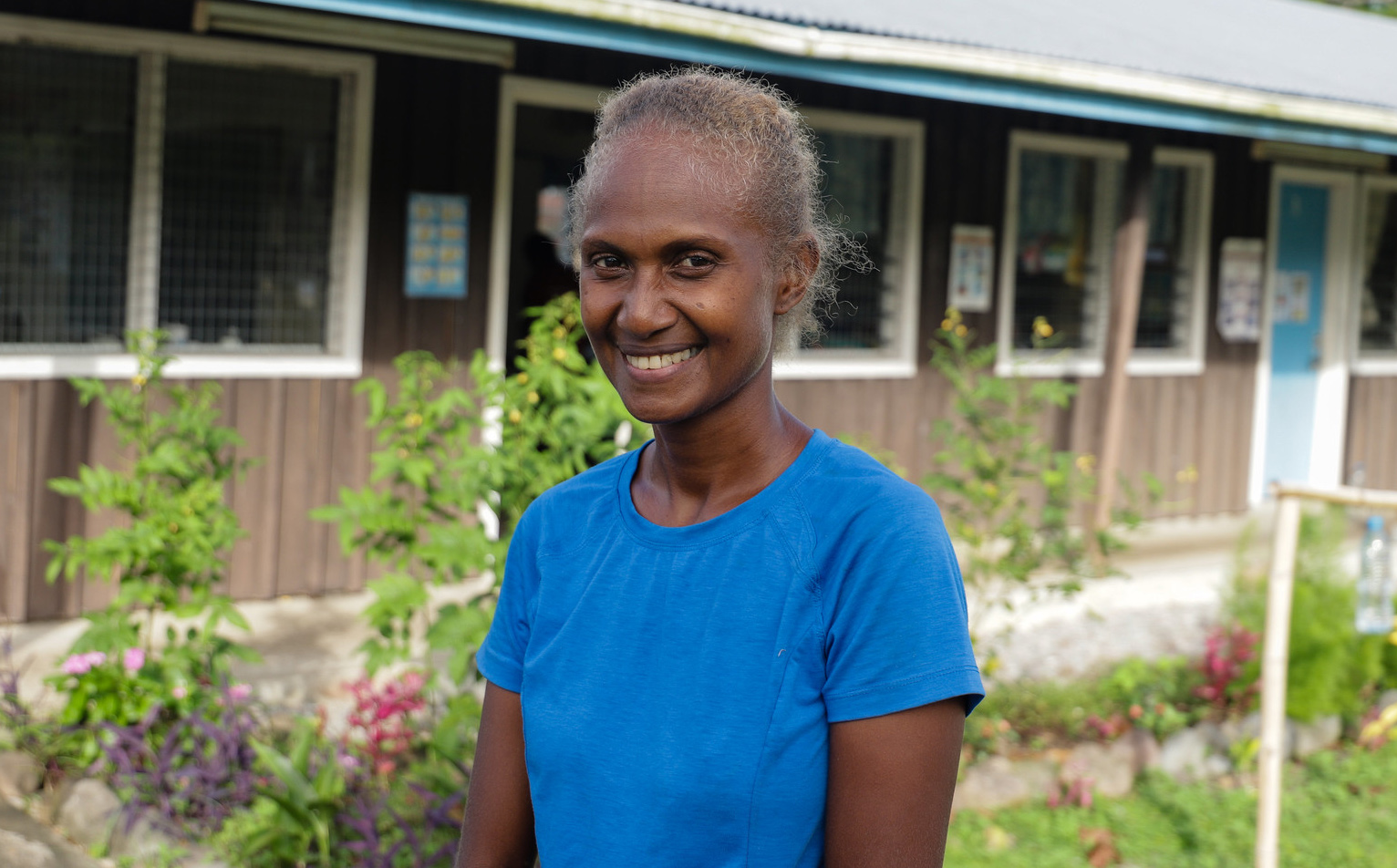 Margret standing outside a school in the Solomon Islands