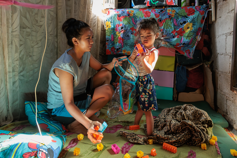 Ronita with her son Egzy in their home in the Philippines. Photo: Richard Wainwright/Caritas Australia
