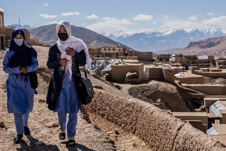 Afghan women walking down the street with protective face masks. Photo credit: CRS.