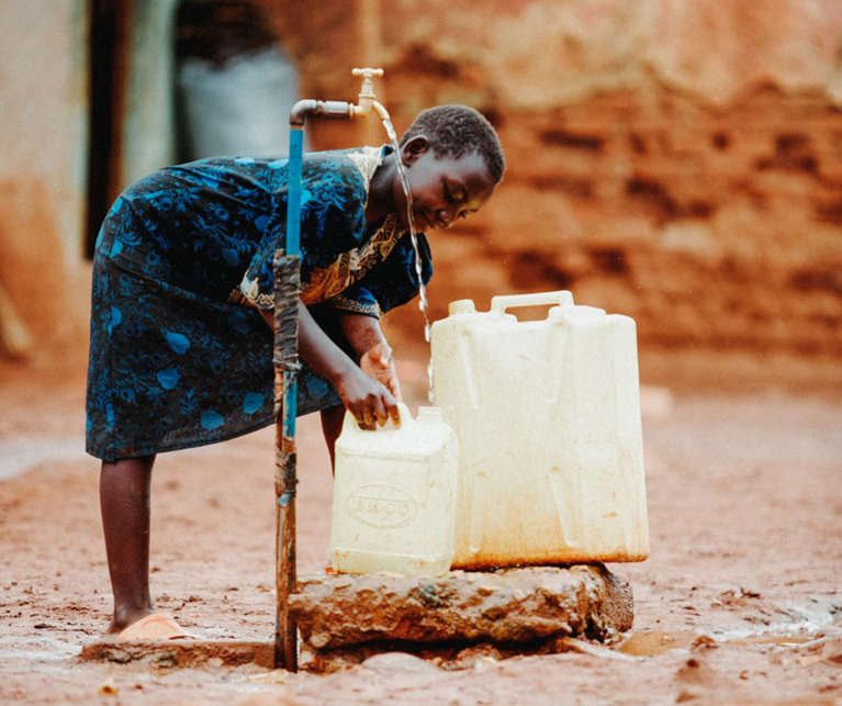 A young girl collects clean water from a supply at her home near Kawempe in Uganda. Australia recognises the importance of access to clean water to the health and livelihoods of people. Photo: Kate Holt/Africa Practice