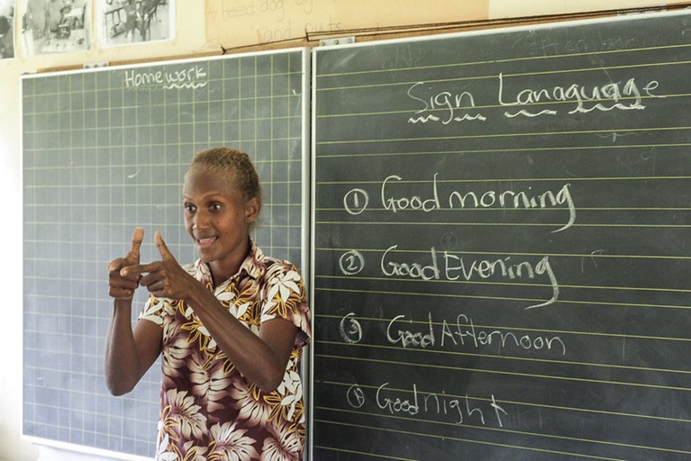 Margret teaching students at her school. Photo: Neil Nuia/Caritas Australia