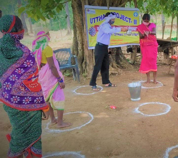 People Social Distancing Near a Handpump in India