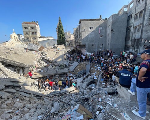 Collapsed building after an airstrike. Photo: Caritas Jerusalem.