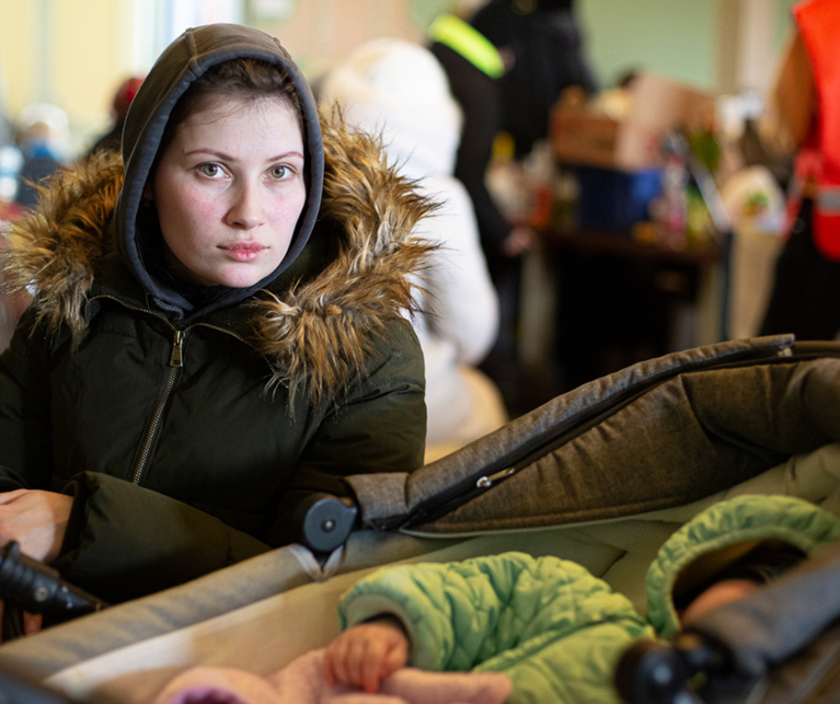 A mother and her 9 month old son, fleeing conflict in Ukraine. Photo: Philipp Spalek/Caritas