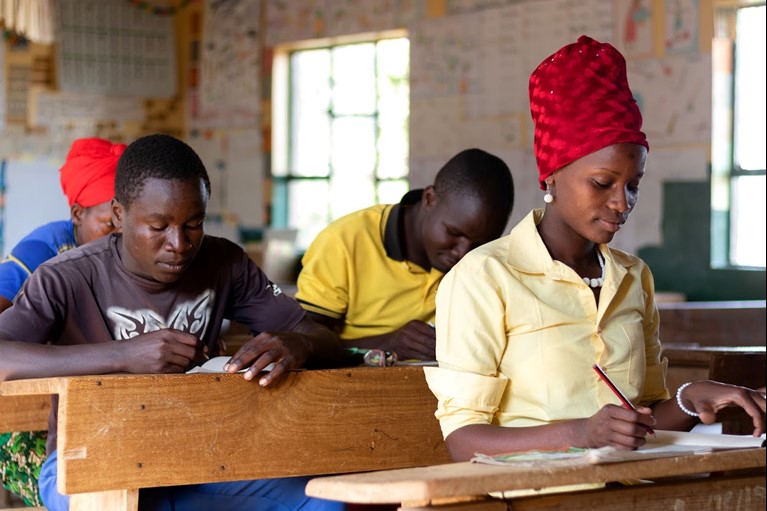 After growing up illiterate, Oliva from Tanzania attended an Adults Learning Program run by Caritas Australia partner DMDD. She can now read, write and count and this has enabled her to run her small kiosk and restaurant more efficiently without people taking advantage of her. She now feels closer to her children after being able to help them with their homework. To give back to her community, she teaches other adults at her home who are too shy to go to the same school as their children. She motivates them and they hope to be like her one day. Photo credit: Richard Wainwright/Caritas Australia.