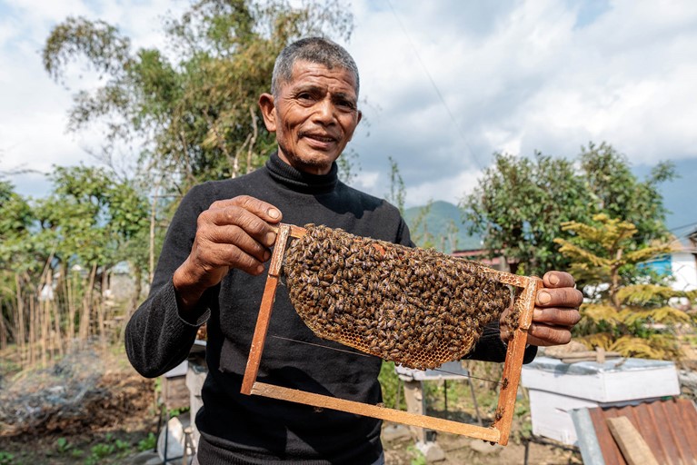Chandrabahadur is a beekeeper who generates income from selling honey. Photo: Richard Wainwright/Caritas Australia