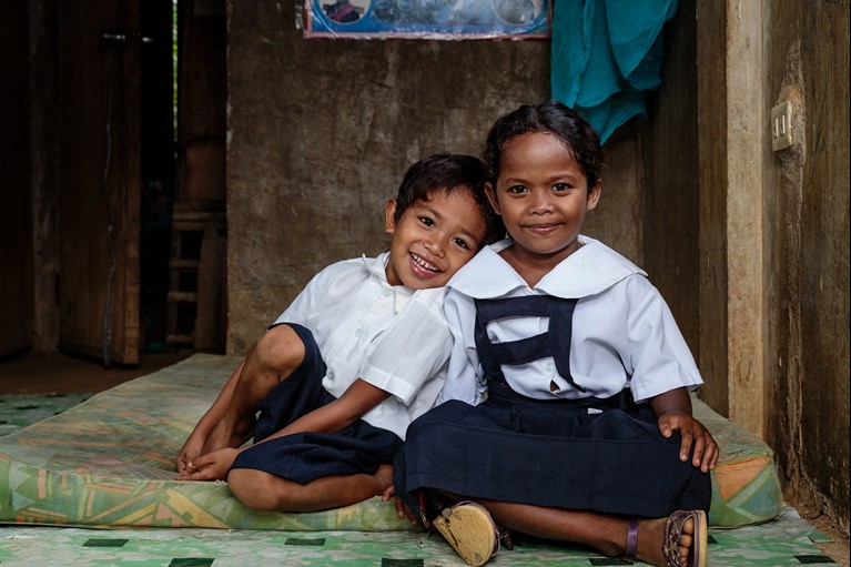 Angelo and Angel preparing to go to school in the Philippines. Photo: Richard Wainwright/Caritas Australia.