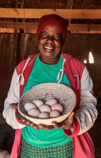 Priscilla with eggs from her poultry farming. Photo: Richard Wainwright/Caritas Australia