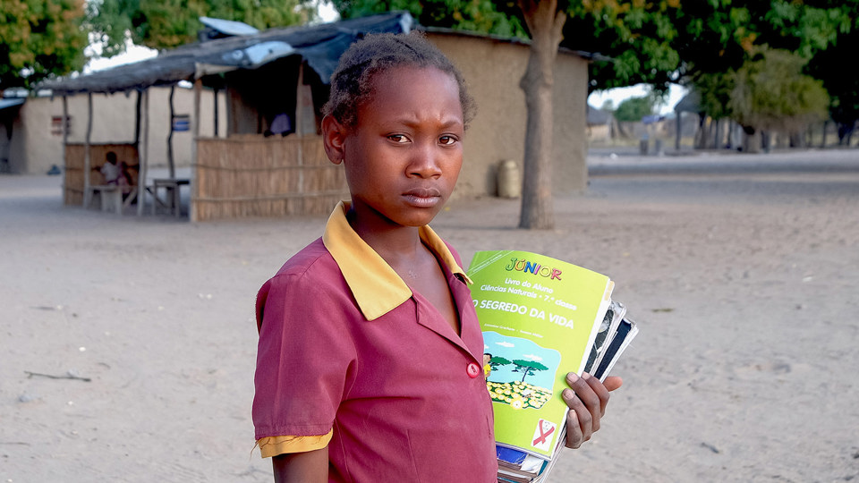 Anatercia walks to her local school in her village in Mozambique