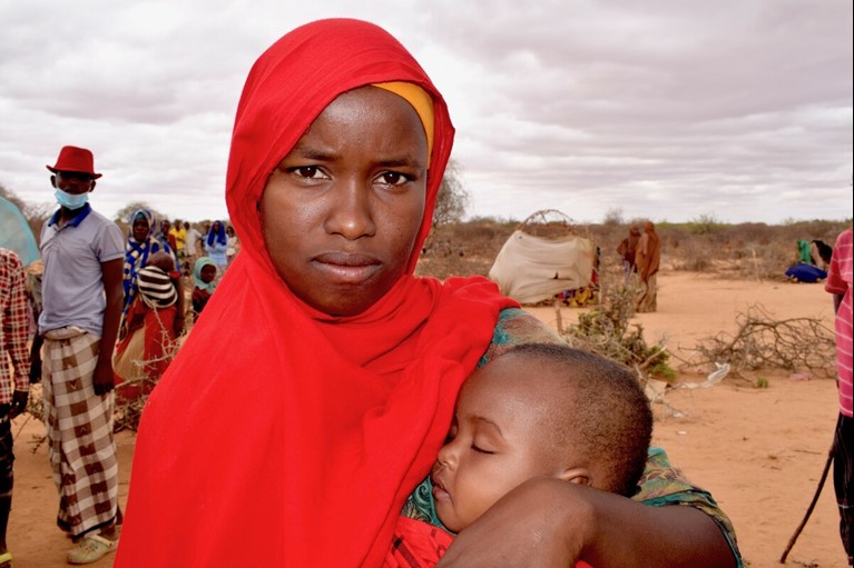 Marian and her eight-month-old daughter queuing at the Trócaire health outreach centre at an Internally Displaced Persons camp in Gedo district, southern Somalia. Trócaire is one of Caritas Australia’s partners. Photo: Miriam Donohue: Trócaire.