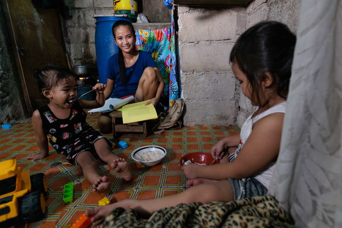 Ronita Doing School Work In Her Home In The Urban Slums