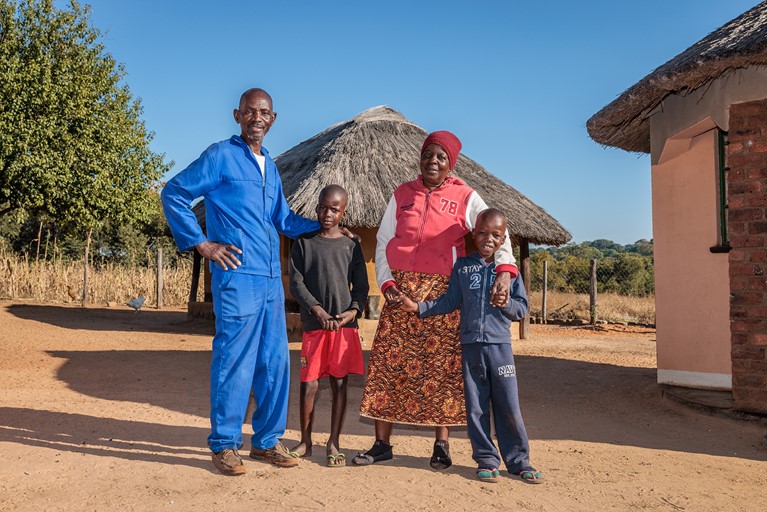 Priscilla, her husband Charles and their grandsons Obry (8) and Jayden (7) outside their home in Hwange district, north western Zimbabwe. Photo: Richard Wainwright/Caritas Australia
