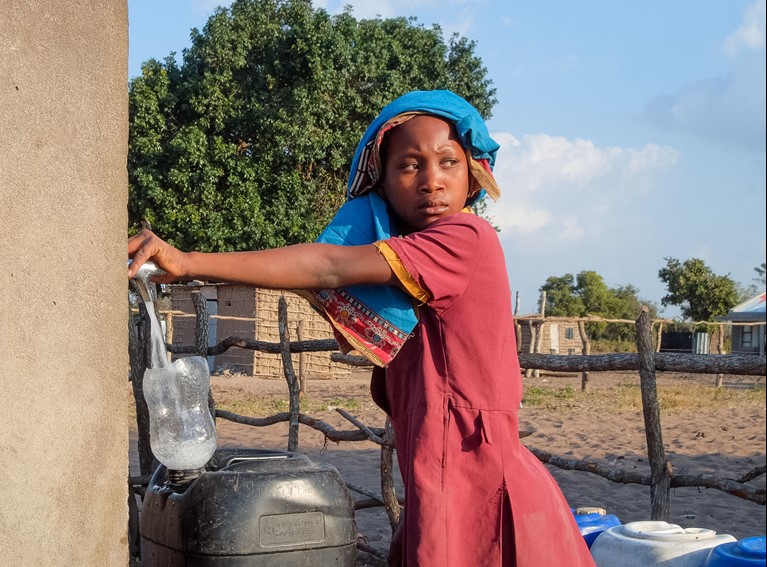 Anatercia collects water from the  community water tap near her house in Mozambique. Photo credit: Emidio Josine/Caritas Australia.