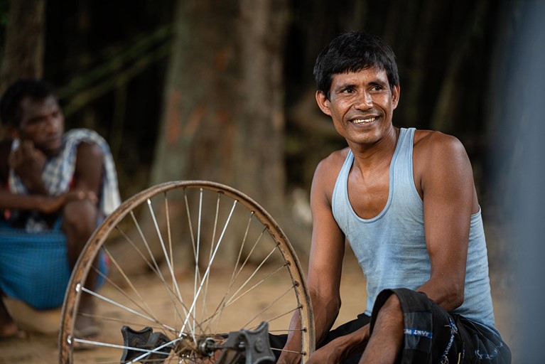 Biru is seen working at his bicycle repair shop outside his home in his village in the state of Jharkhand, India. Photo: Sameer Bara/Caritas Australia