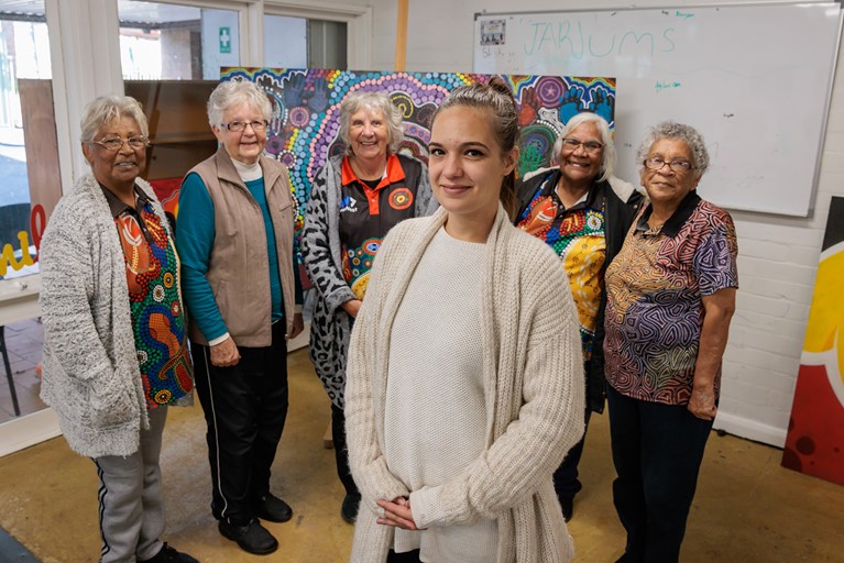 Tereesa poses for a photograph with the founding Elders of Baabayn during the weekly Elders Gathering at Baabayn Aboriginal Corporation in western Sydney. Photo: Richard Wainwright/Caritas Australia