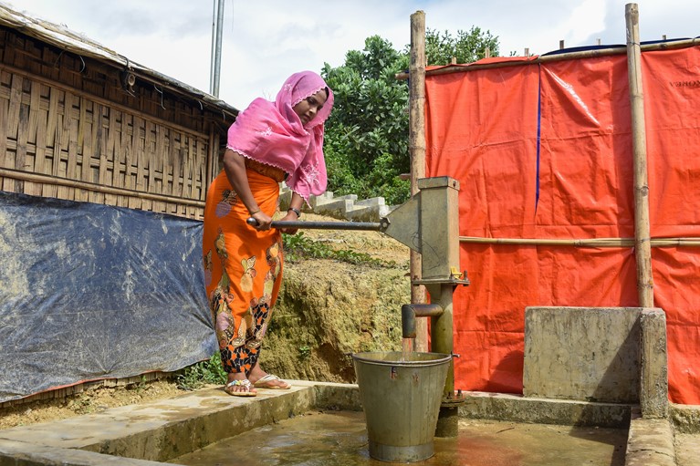 Halima pumps fresh water near her shelter in a Rohingya refugee camp in Cox’s Bazaar region of Bangladesh in August 2020. Photo credit: Inmanuel Chayan Biswas/Caritas Bangladesh.