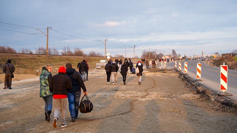 Ukrainian refugees fleeing to safety at Ukraine-Poland border.