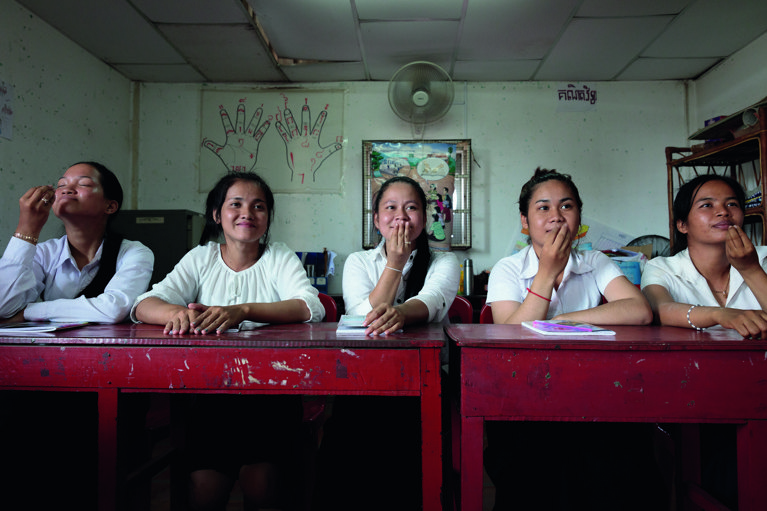 Students of the Caritas Australia-supported Deaf Development Program learning Cambodian sign language. They are also taught how to write in Khmer and take maths and social science classes as part of the two year course. Photo credit: Richard Wainwright/Caritas Australia.