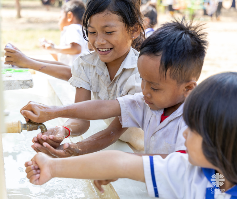 Primary school students in rural Cambodia accessing clean water for hand washing. Photo Caritas Australia