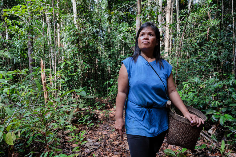 Tati walking in the rainforest in Indonesia. Photo credit: Richard Wainwright/Caritas Australia.