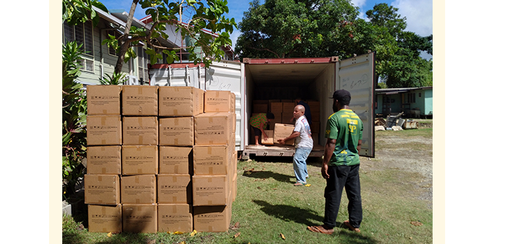Men unpacking truck with PPE in PNG